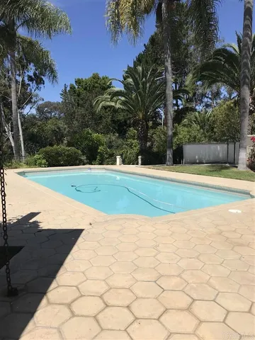 a view of a swimming pool and an outdoor space