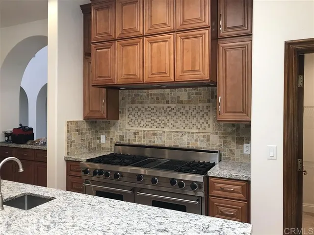 a kitchen with stainless steel appliances granite countertop a stove and a microwave