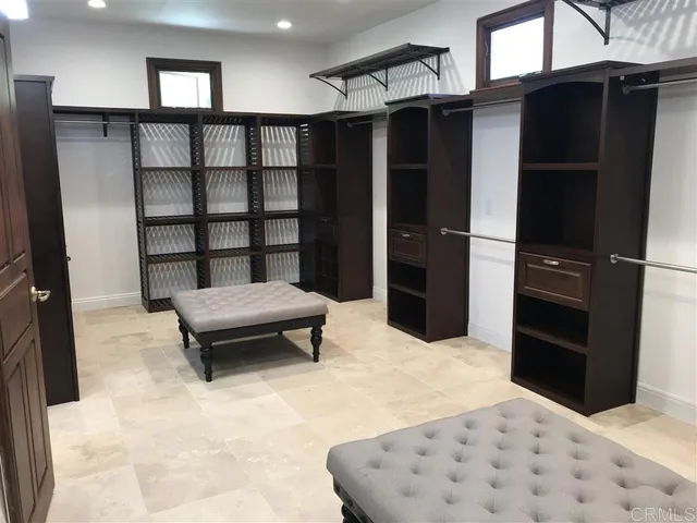 a bedroom with a bed and a television