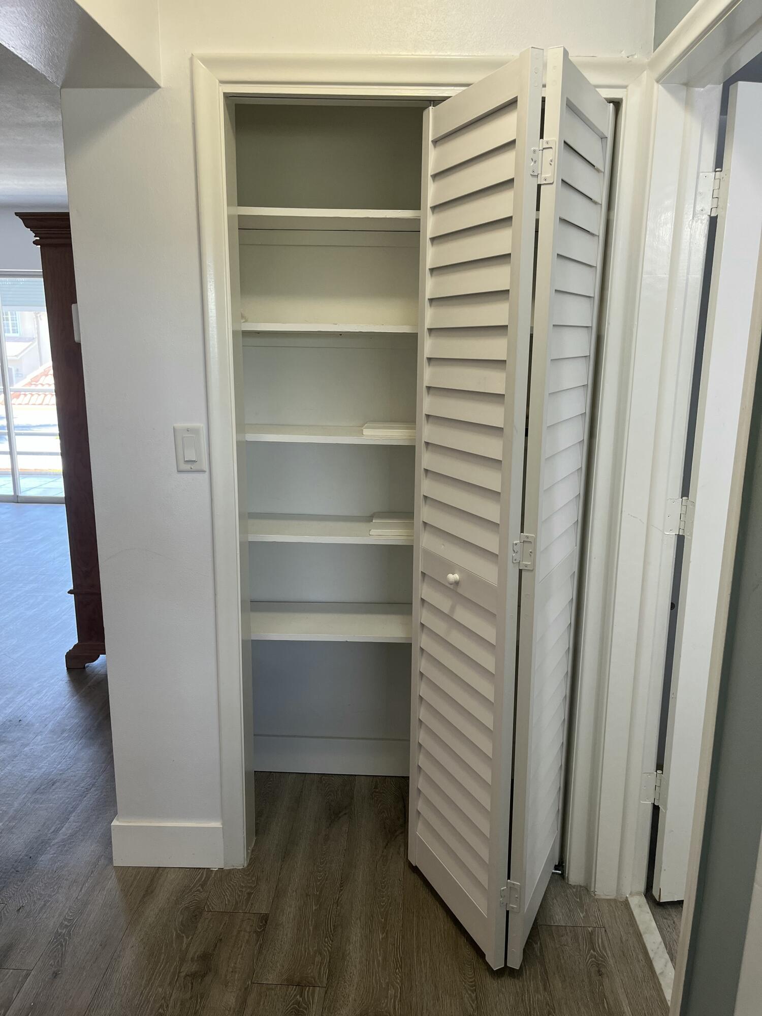 331 Southwest 8th Street, Unit 2CE Boca Raton, FL 33432 - Photo 12 of 19 a view of walk in closet with empty racks