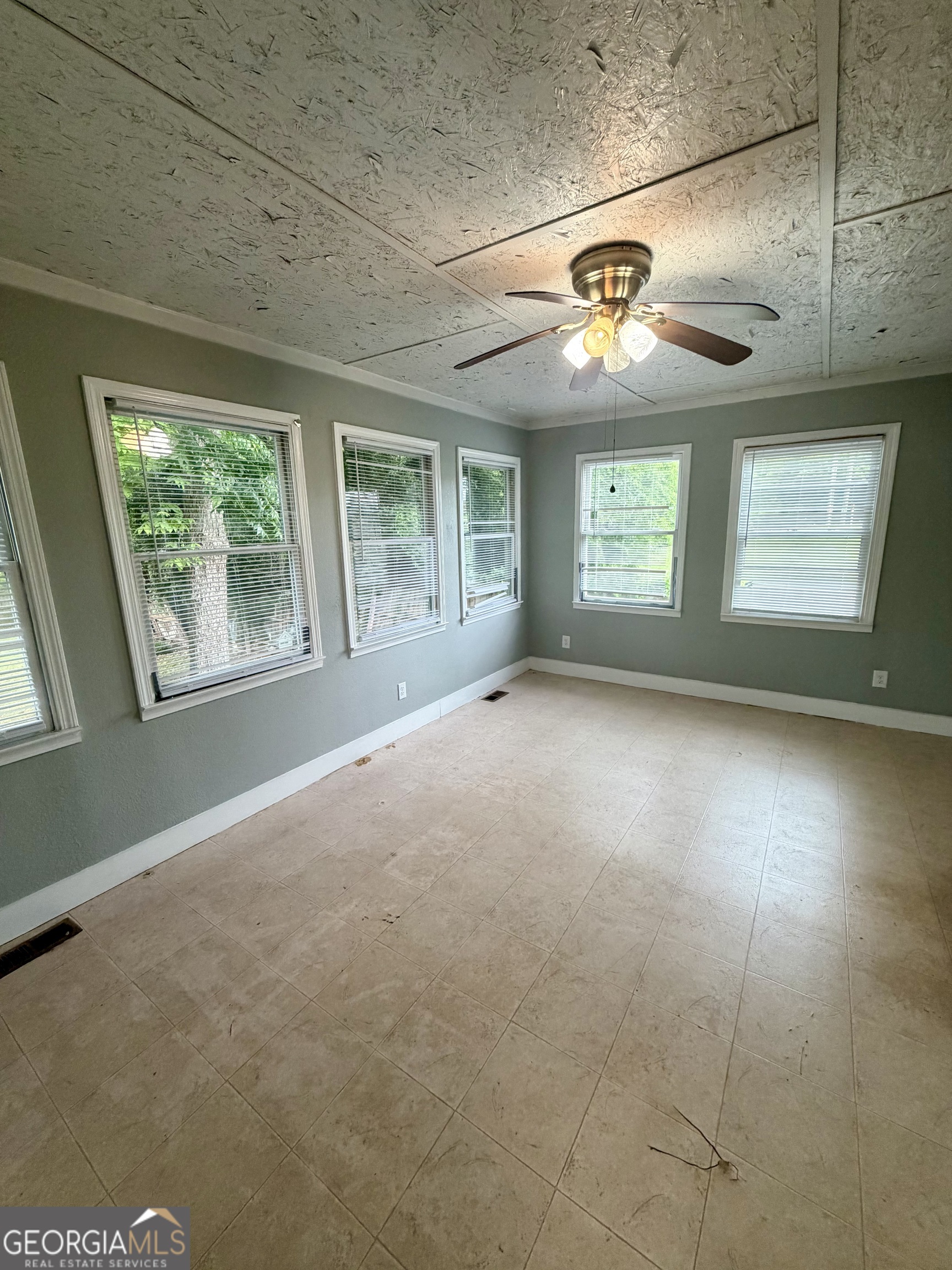 666 Woolfolk Street Macon, GA 31217 - Photo 48 of 60 a view of a livingroom with a chandelier fan and windows