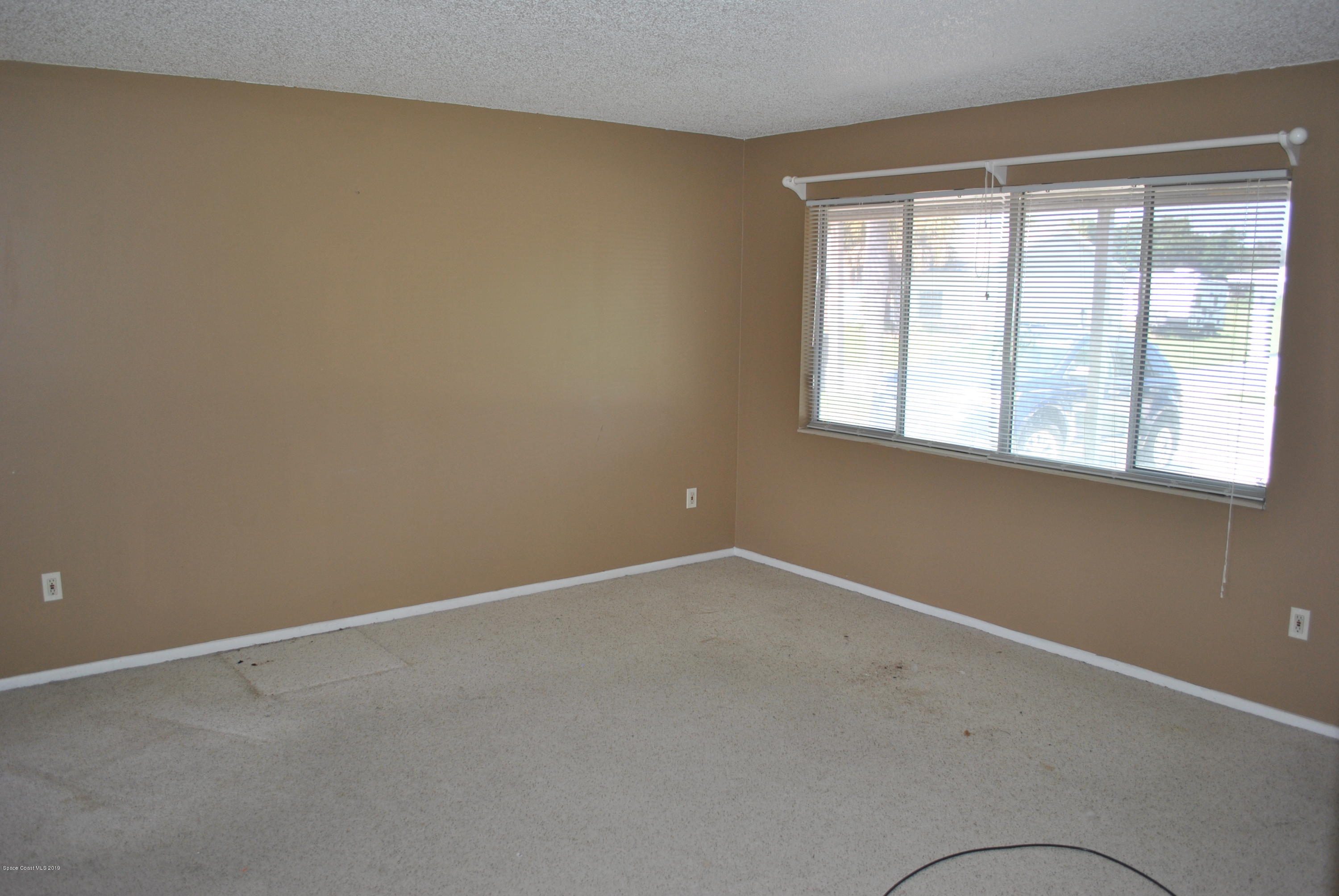 1167 Cotton Road Northeast Palm Bay, FL 32905 - Photo 12 of 34 an empty room with a window
