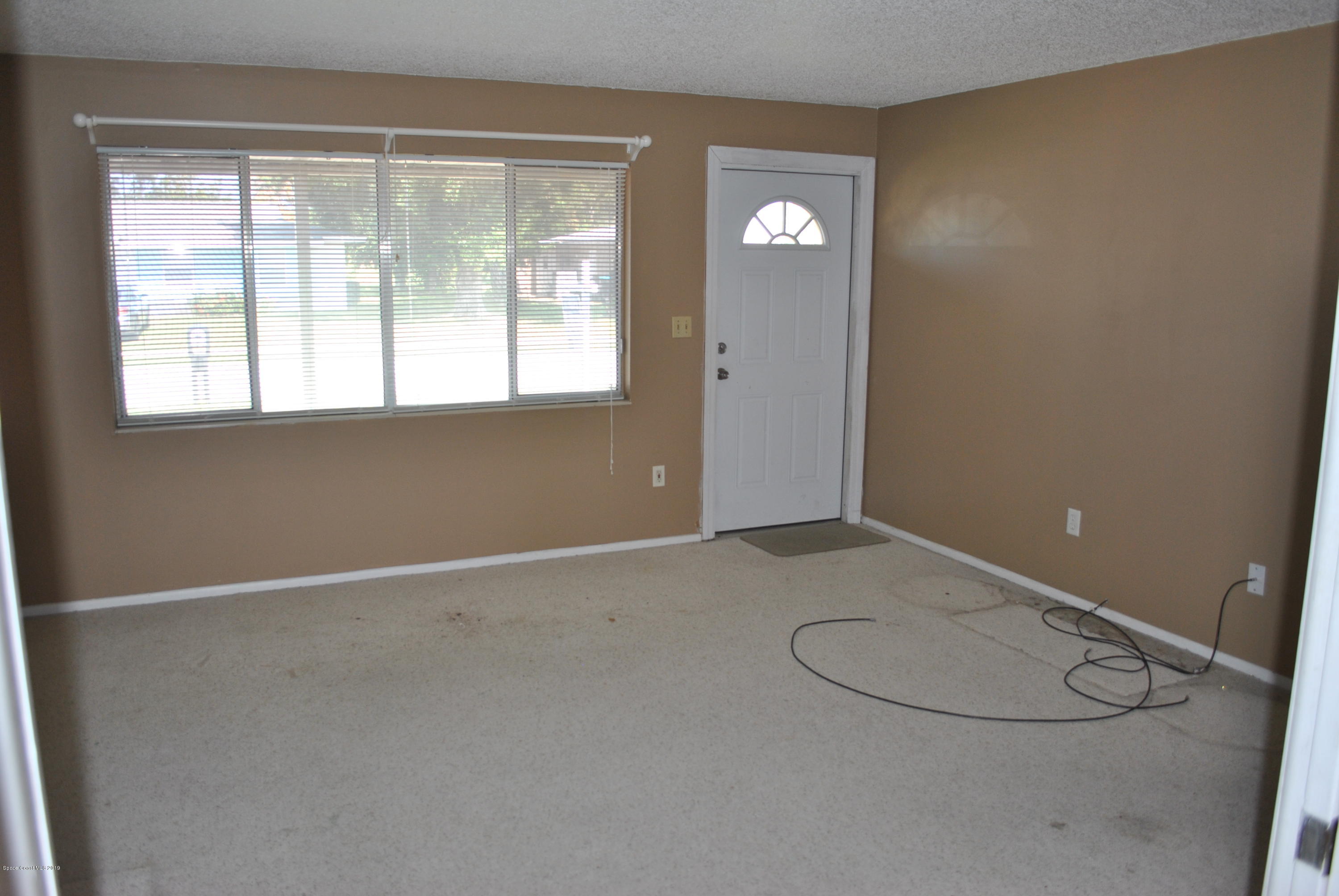 1167 Cotton Road Northeast Palm Bay, FL 32905 - Photo 13 of 34 an empty room with a empty space and windows
