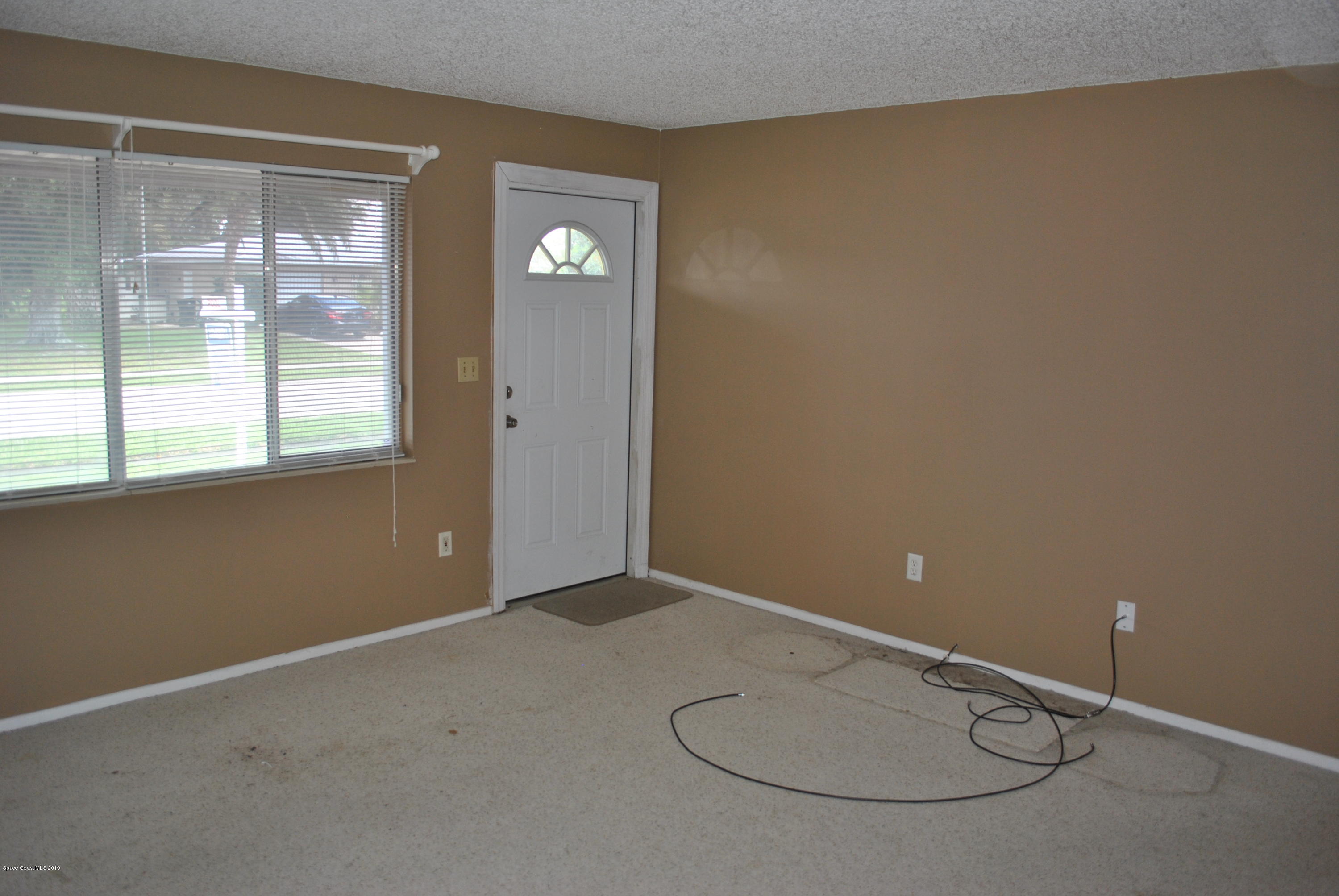 1167 Cotton Road Northeast Palm Bay, FL 32905 - Photo 14 of 34 a view of a livingroom with window
