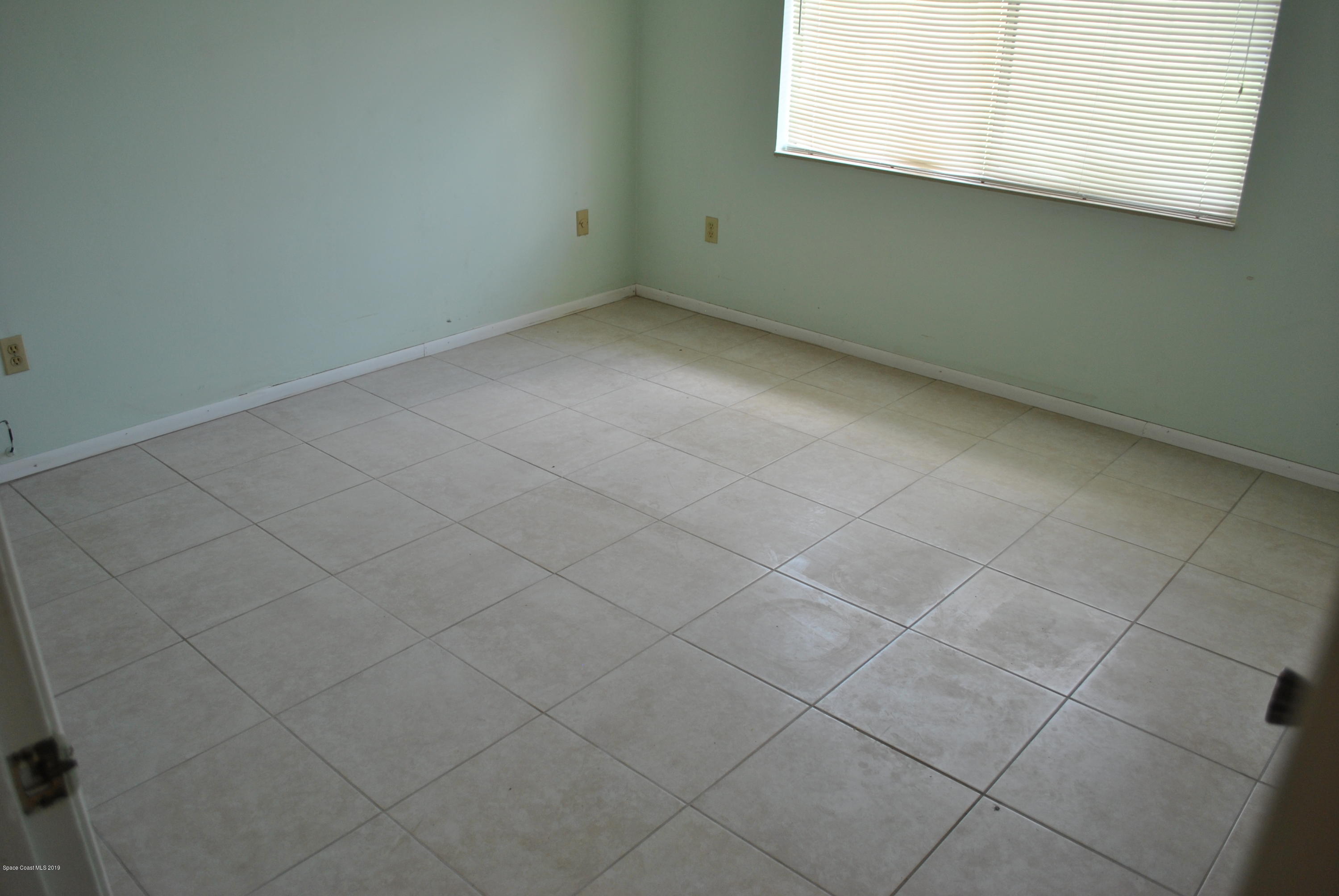 1167 Cotton Road Northeast Palm Bay, FL 32905 - Photo 17 of 34 an empty room with a window