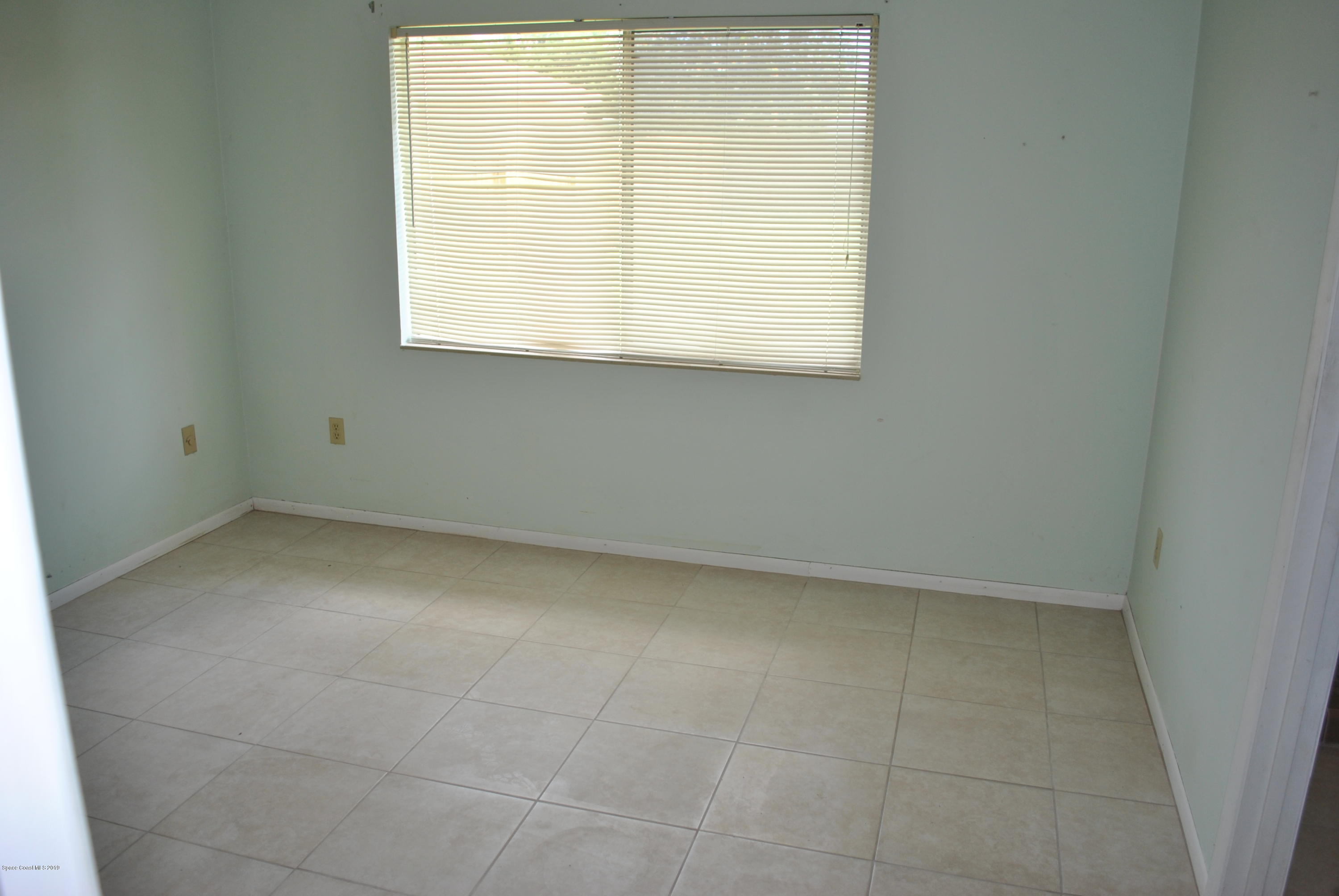 1167 Cotton Road Northeast Palm Bay, FL 32905 - Photo 18 of 34 a view of an empty room with a window