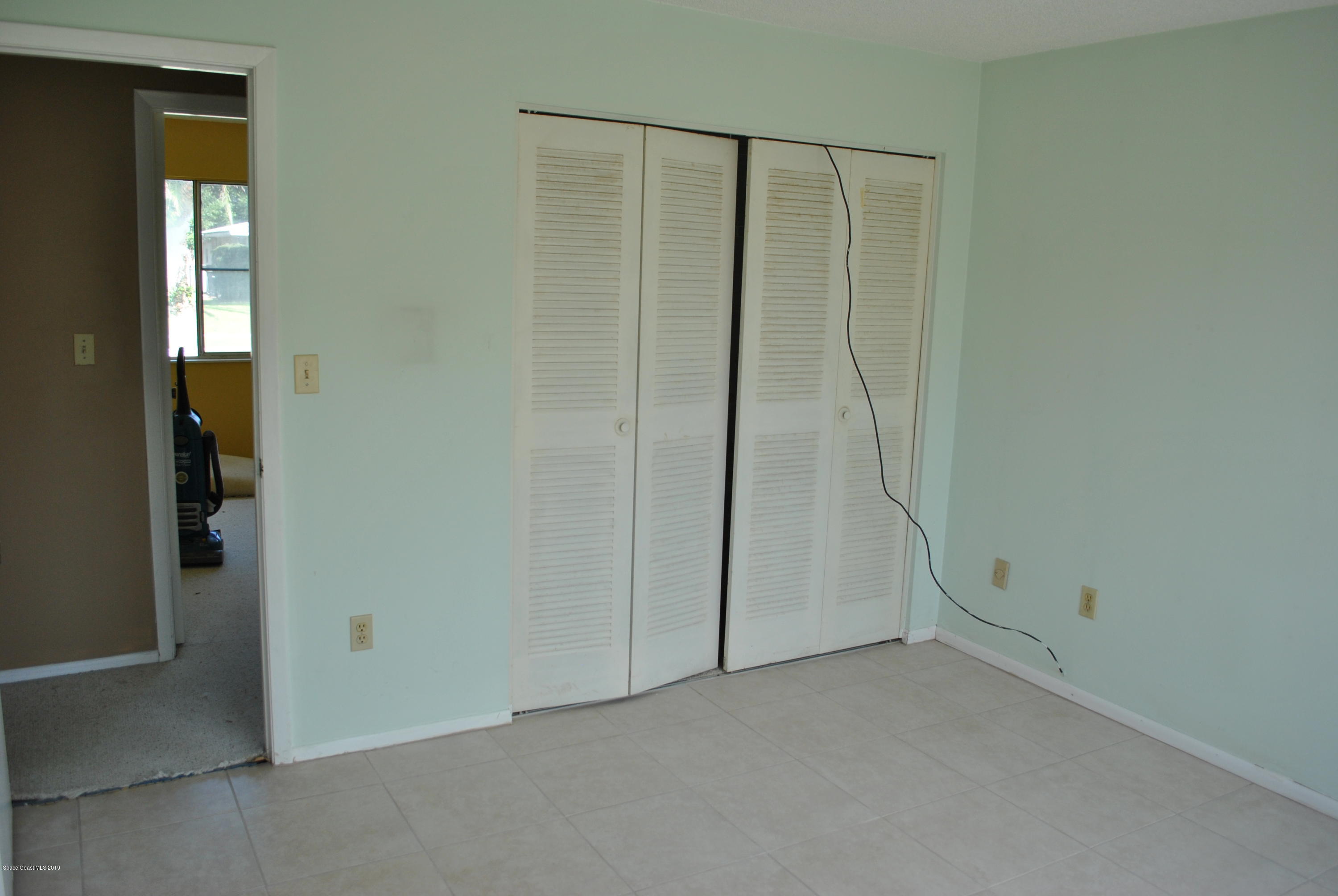 1167 Cotton Road Northeast Palm Bay, FL 32905 - Photo 19 of 34 an empty room with a door