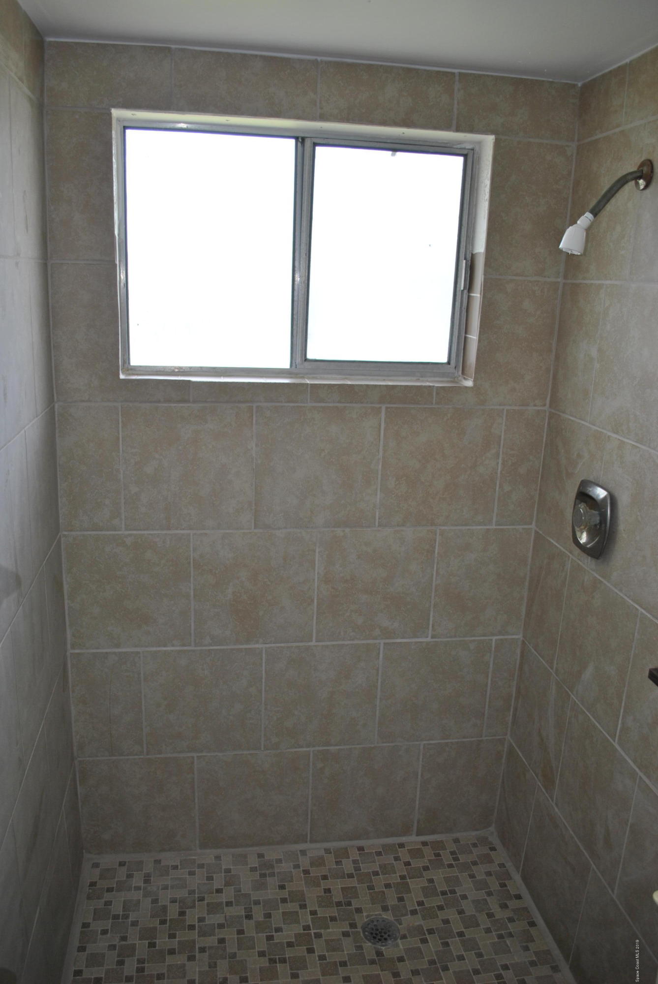 1167 Cotton Road Northeast Palm Bay, FL 32905 - Photo 21 of 34 a bathroom with a window