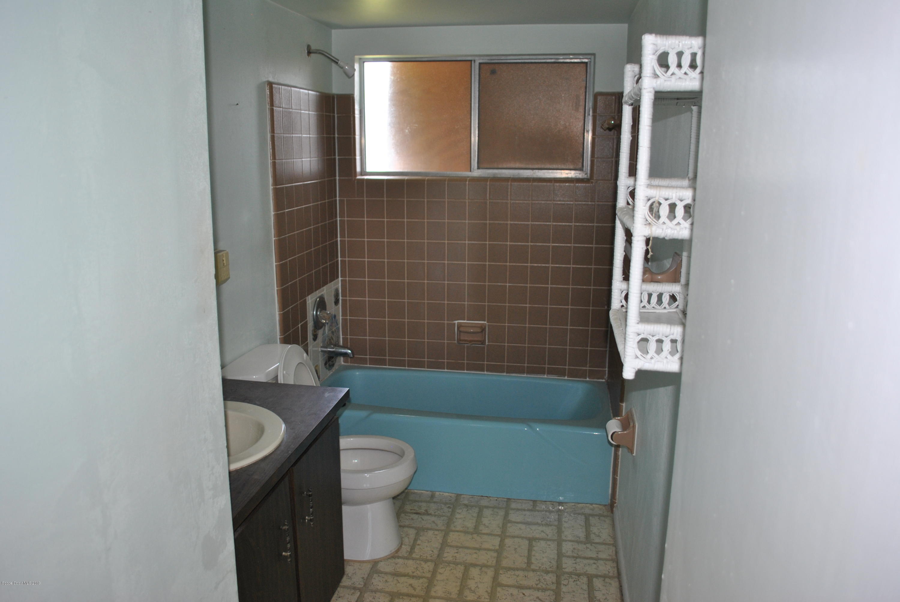 1167 Cotton Road Northeast Palm Bay, FL 32905 - Photo 22 of 34 a bathroom with a toilet and shower