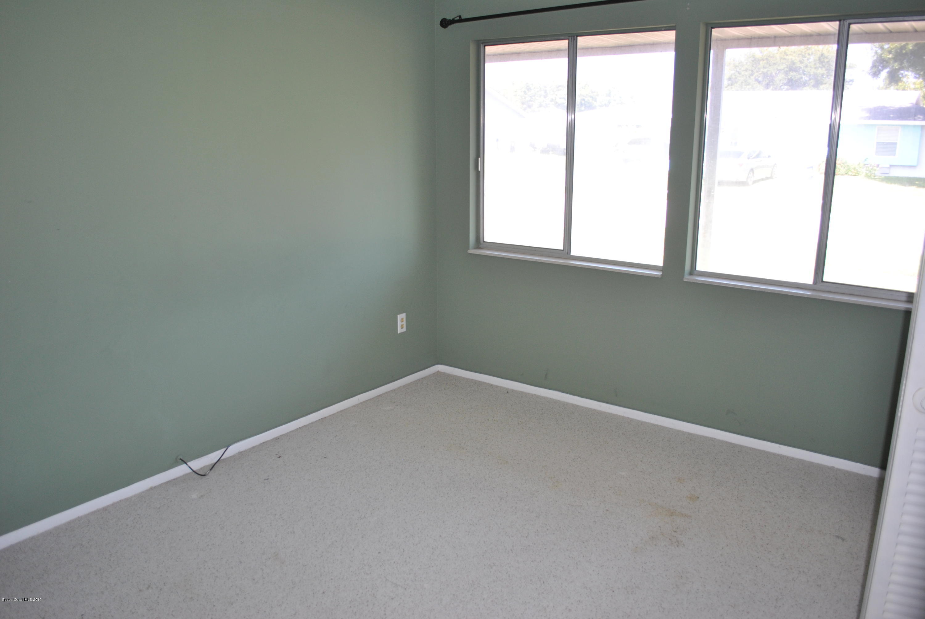1167 Cotton Road Northeast Palm Bay, FL 32905 - Photo 24 of 34 an empty room with a window