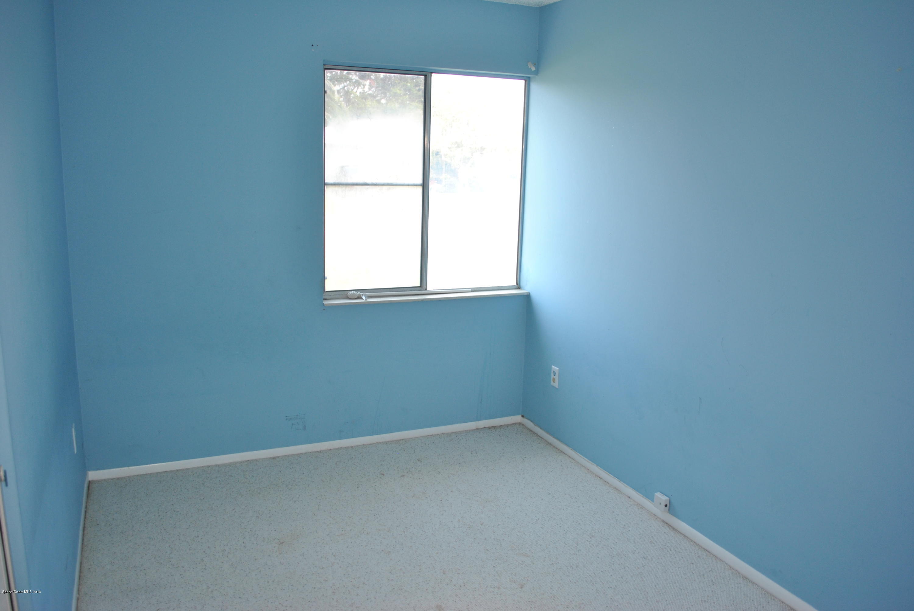 1167 Cotton Road Northeast Palm Bay, FL 32905 - Photo 25 of 34 an empty room with a window