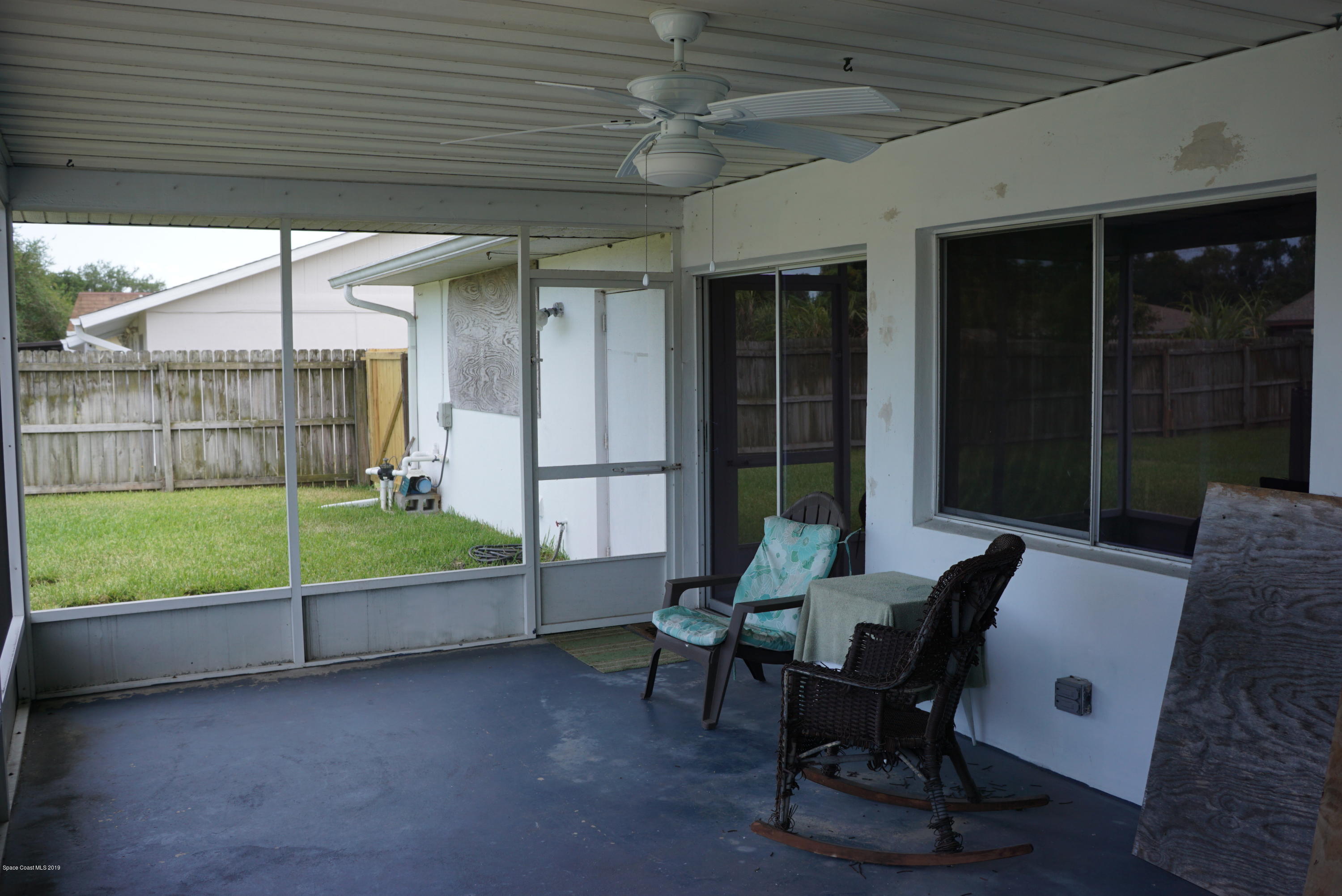 1167 Cotton Road Northeast Palm Bay, FL 32905 - Photo 28 of 34 a view of a porch with furniture and floor to ceiling window