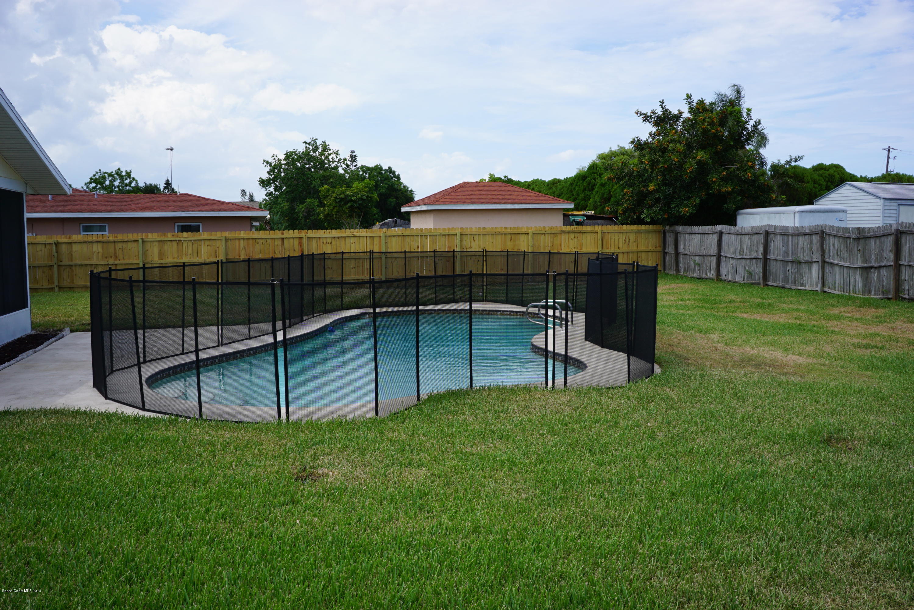 1167 Cotton Road Northeast Palm Bay, FL 32905 - Photo 31 of 34 a view of a backyard with a garden and deck