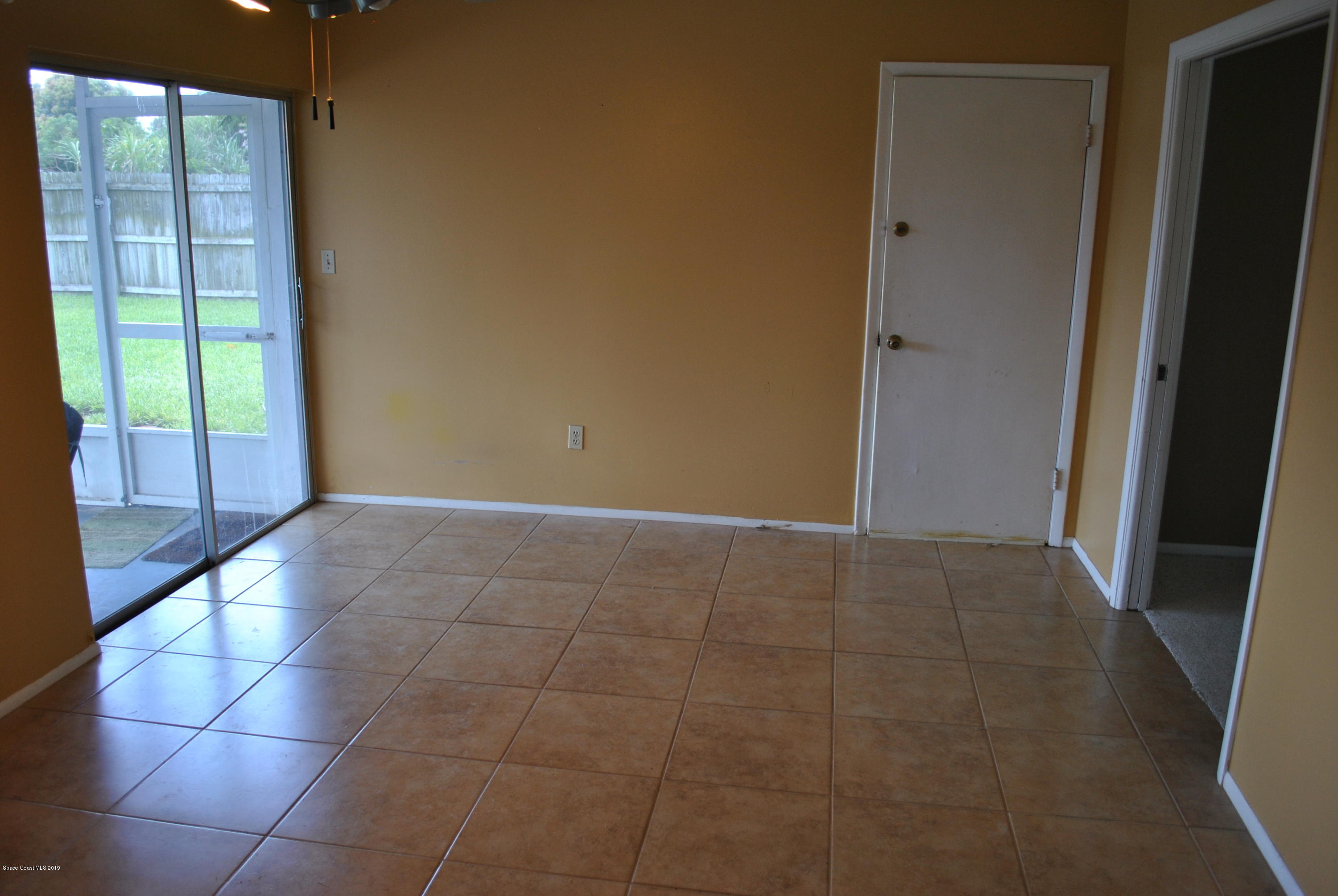 1167 Cotton Road Northeast Palm Bay, FL 32905 - Photo 9 of 34 a view of an empty room with a window