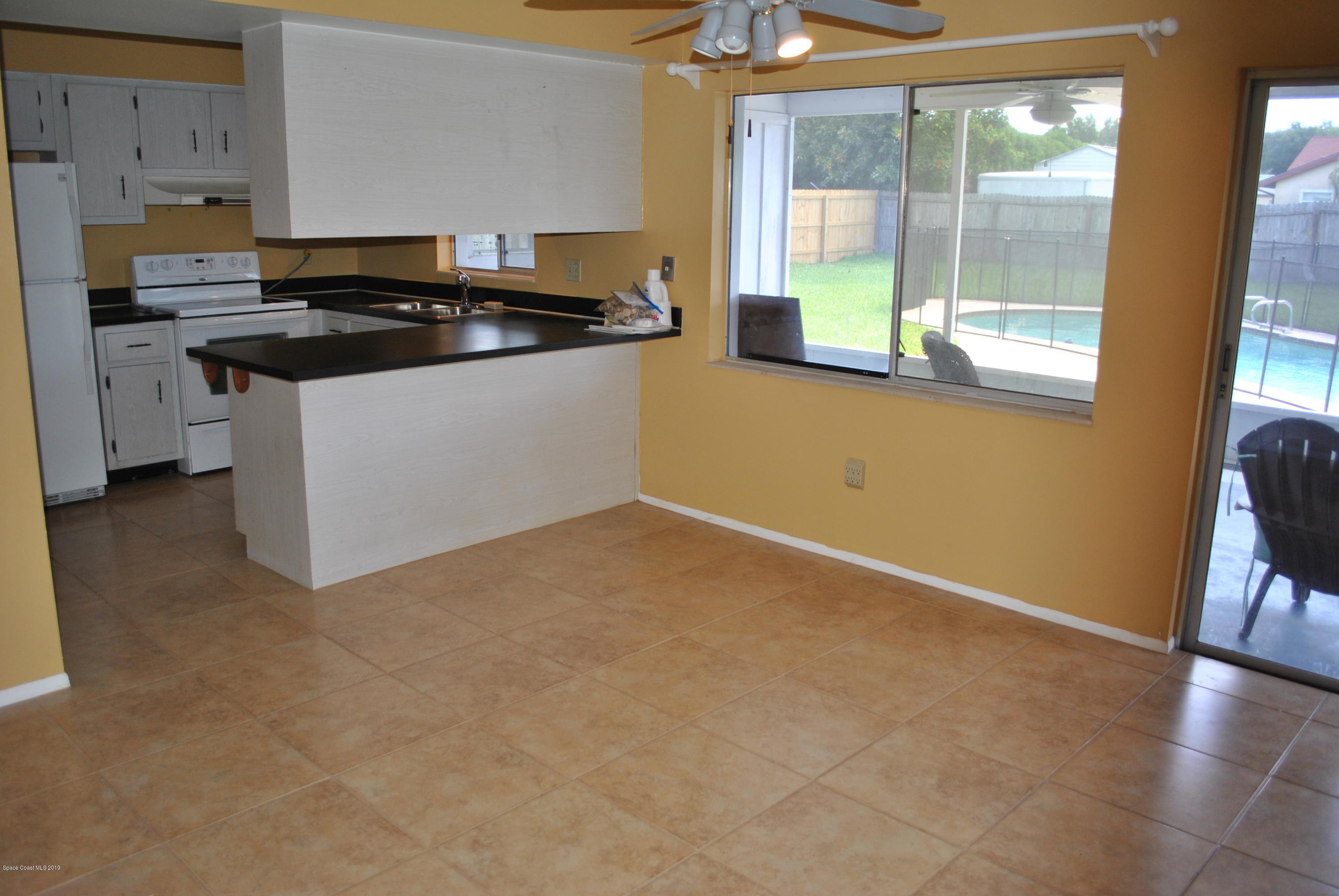 1167 Cotton Road Northeast Palm Bay, FL 32905 - Photo 10 of 34 a kitchen with a stove a sink and a granite counter tops