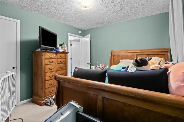 a living room with patio furniture and a fireplace