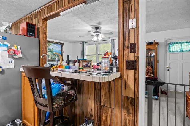 a view of a dining room with furniture and chandelier