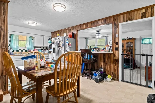 a view of a dining room with furniture and a chandelier