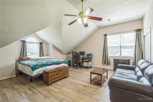 a bedroom with a bed couch and window