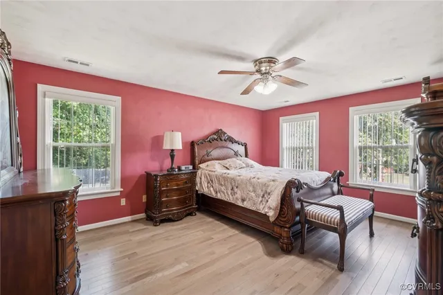 a spacious bedroom with a bed and a couch