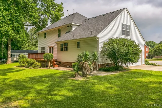 a view of a house with a yard and sitting area