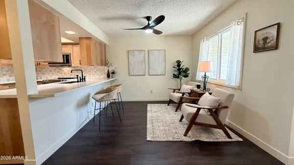 a kitchen with stainless steel appliances a dining table chairs and a refrigerator a sink