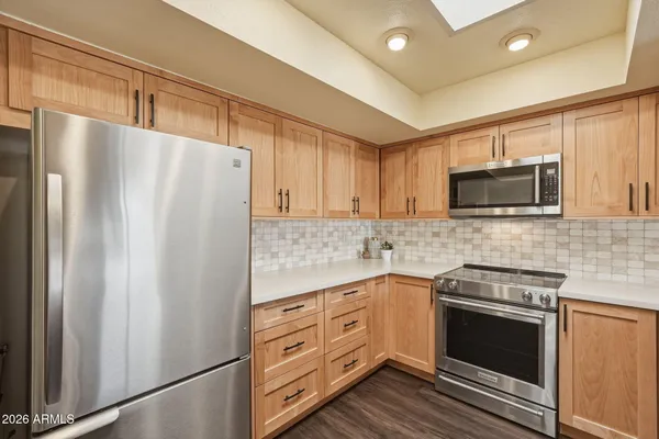 a kitchen with a sink stove and microwave