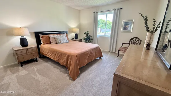 a kitchen with stainless steel appliances a dining table chairs and a refrigerator a sink