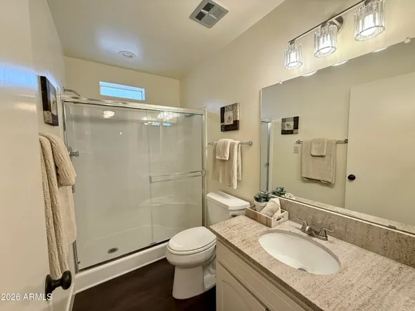 a bedroom with a bed and large windows