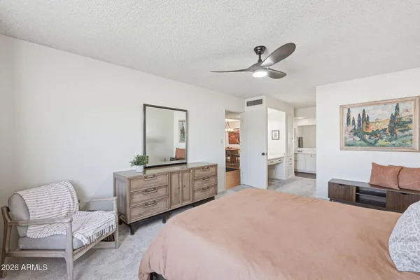 a bedroom with furniture and a large window