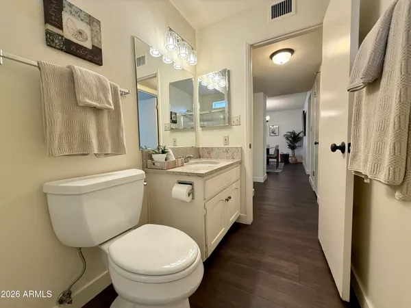 a bathroom with a granite countertop sink toilet and shower