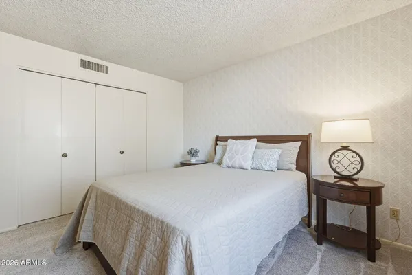 a bedroom with a bed and a chandelier