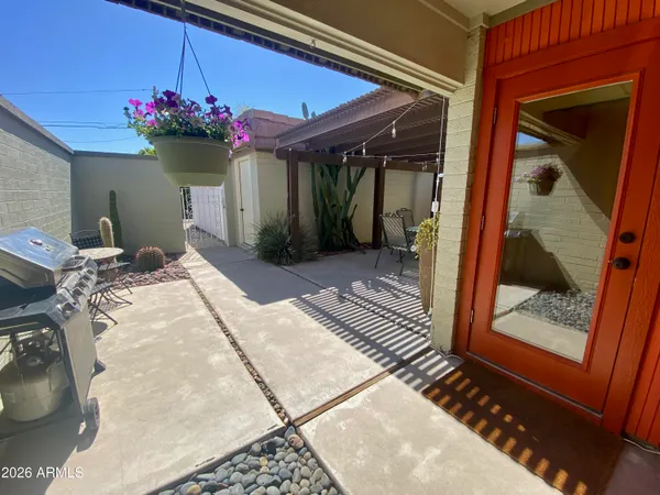 a outdoor patio with table and chairs
