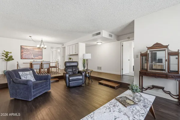 a living room with furniture flat screen tv and wooden floor