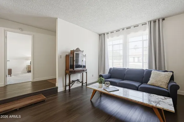 a living room with furniture and wooden floor