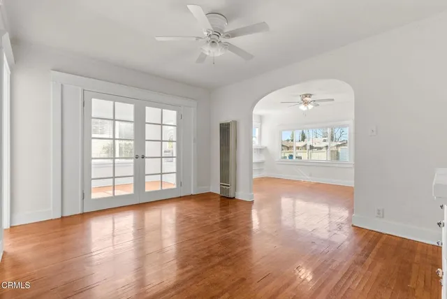 wooden floor in an empty room with a window