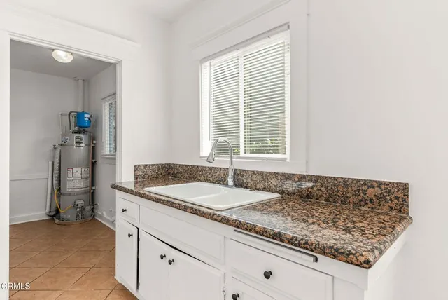 a view of hallway with window and hardwood floor