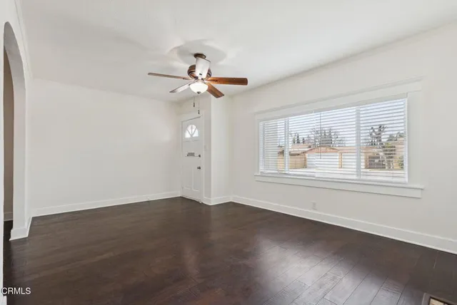 a bathroom with a granite countertop sink a mirror and a window
