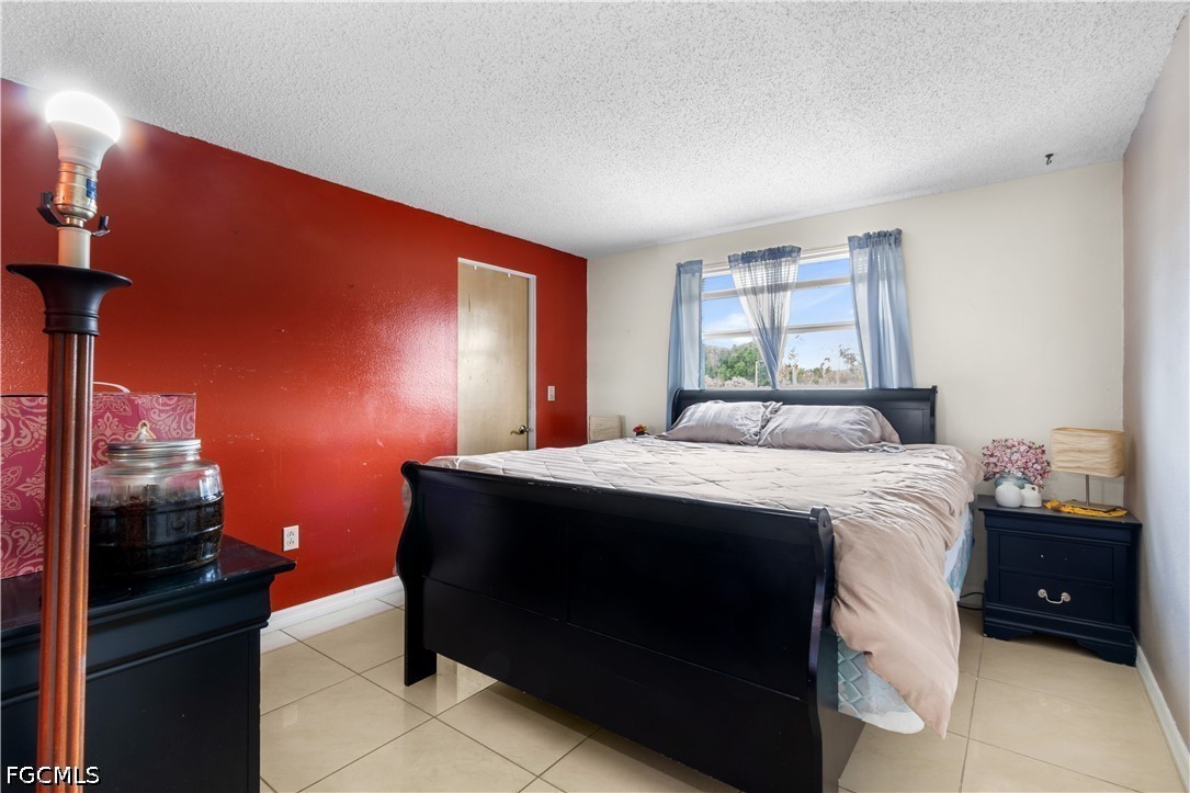 18 Illinois Road Lehigh Acres, FL 33936 - Photo 25 of 45 a bedroom with a bed and a window