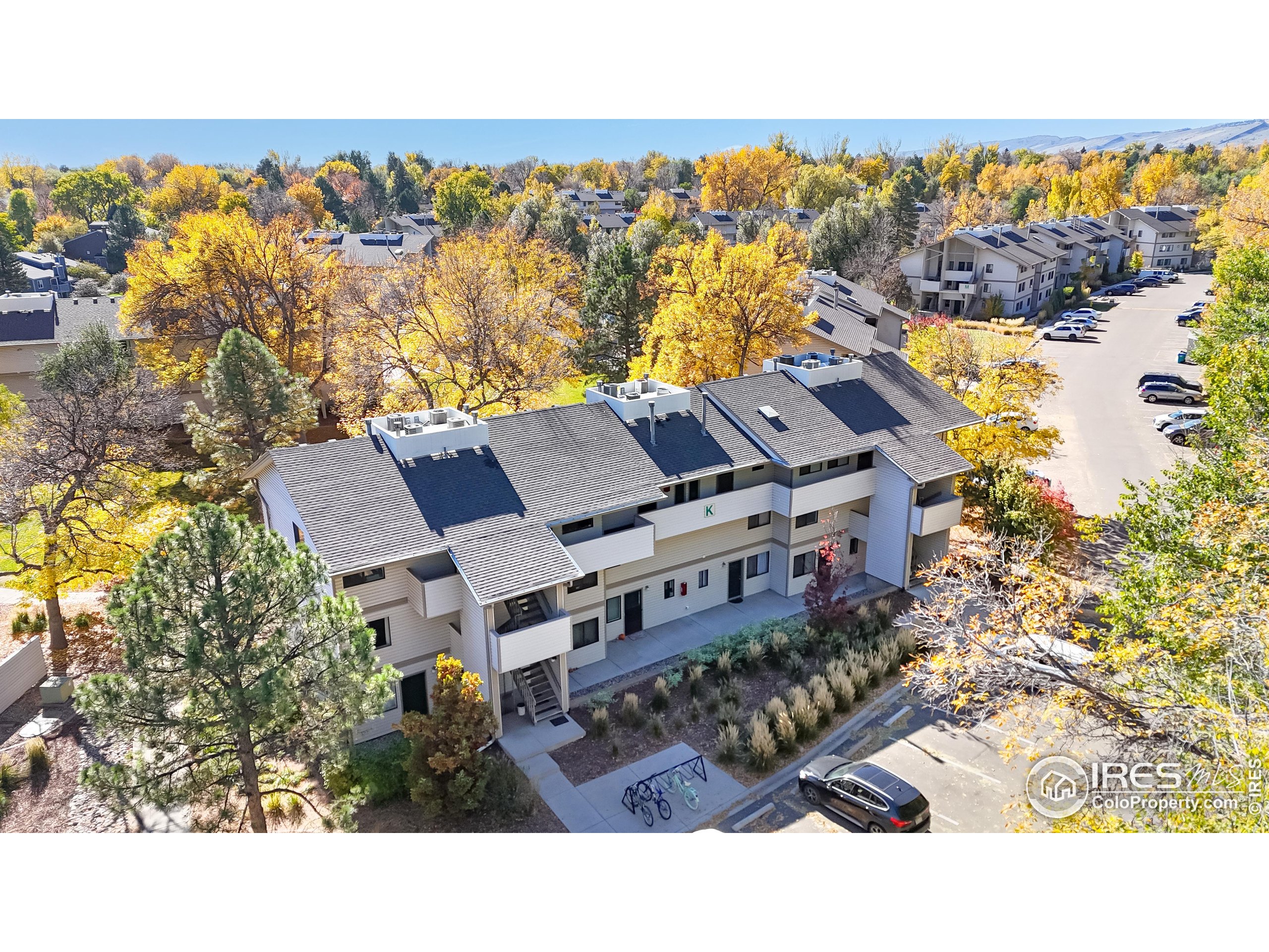 1705 Heatheridge Road, Unit K105 Fort Collins, CO 80526 - Photo 1 of 30 a view of houses with an outdoor space and seating