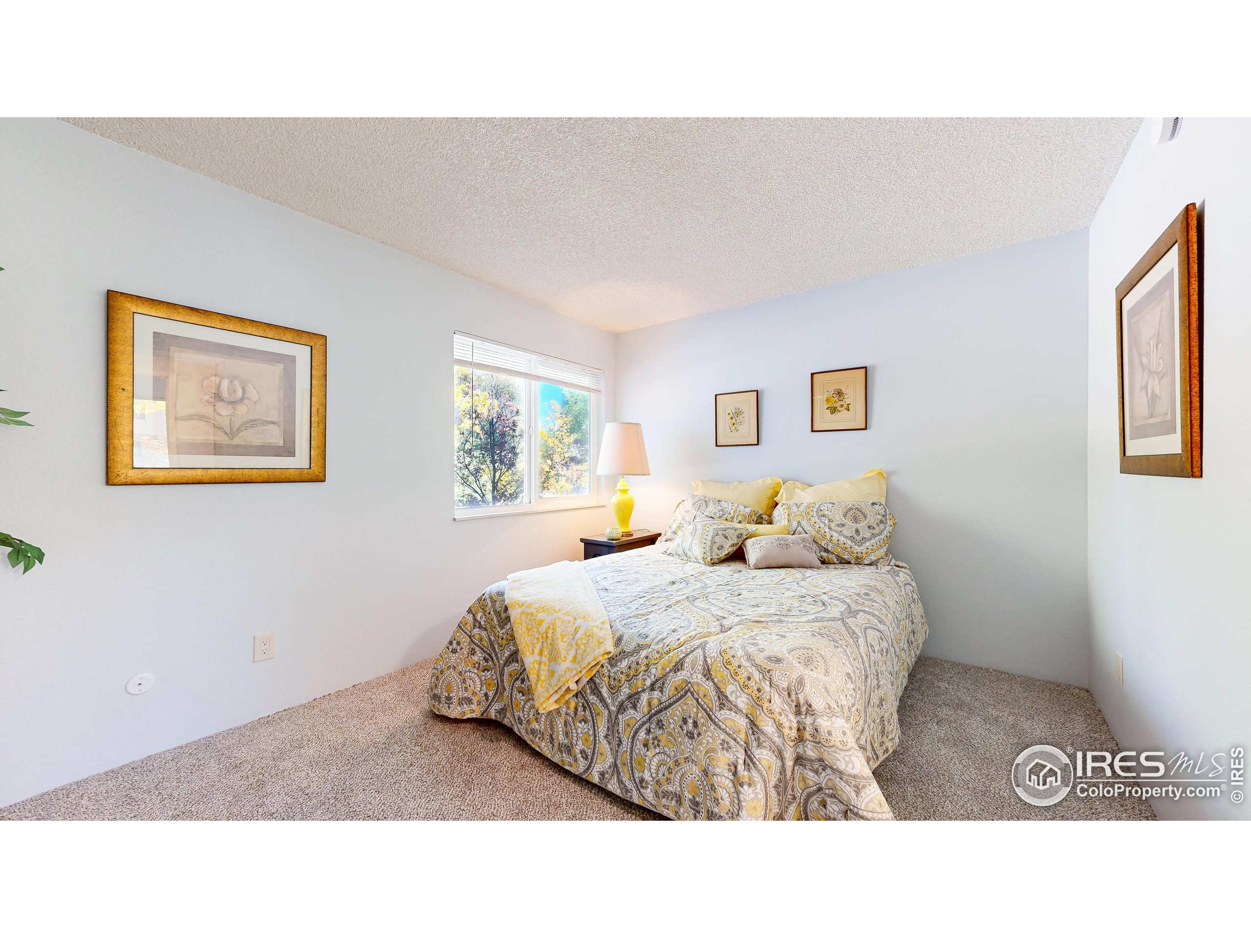 1705 Heatheridge Road, Unit K105 Fort Collins, CO 80526 - Photo 11 of 30 a bedroom with a bed and painting on the wall