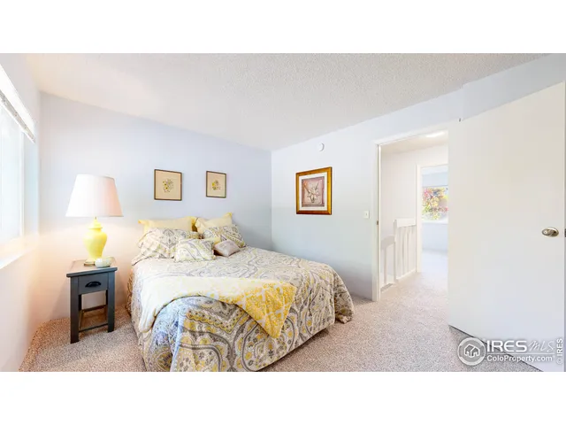 a bedroom with a bed and a lamp