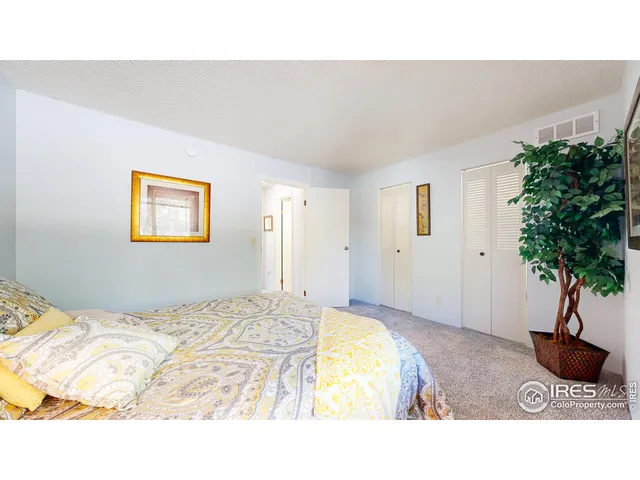 a bedroom with a bed and a potted plant