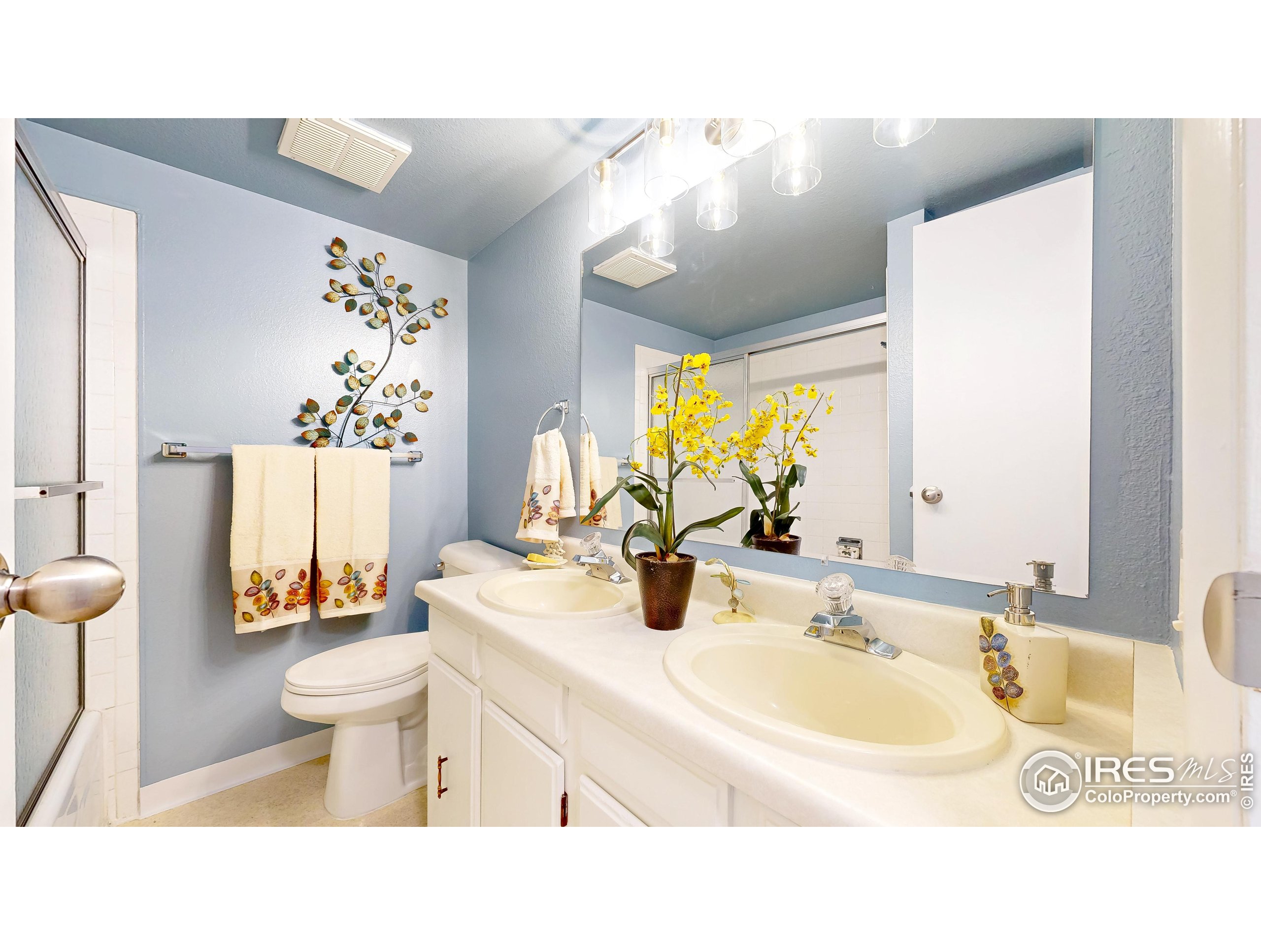 1705 Heatheridge Road, Unit K105 Fort Collins, CO 80526 - Photo 14 of 30 a bathroom with a sink toilet mirror and shower