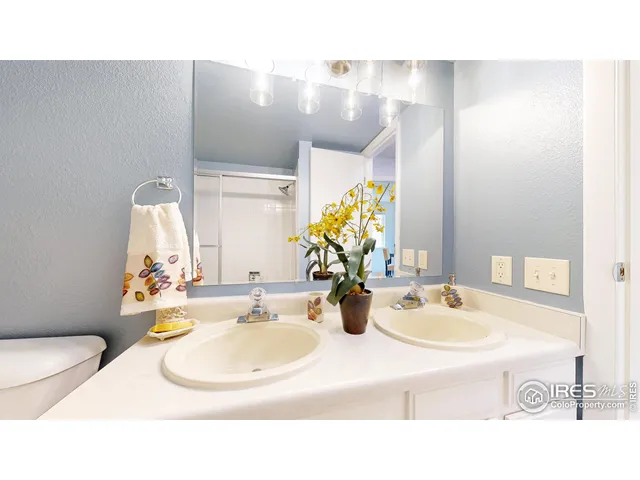 a bathroom with a sink mirror and vanity