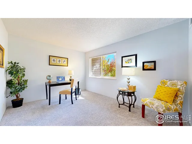 a living room with furniture and flowers