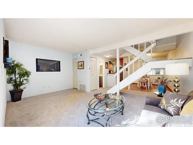a living room with furniture and flowers
