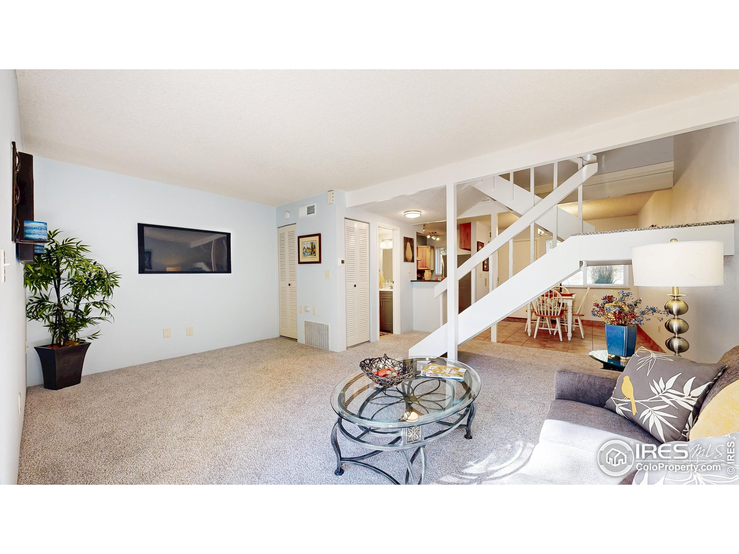 1705 Heatheridge Road, Unit K105 Fort Collins, CO 80526 - Photo 5 of 30 a living room with furniture and flowers