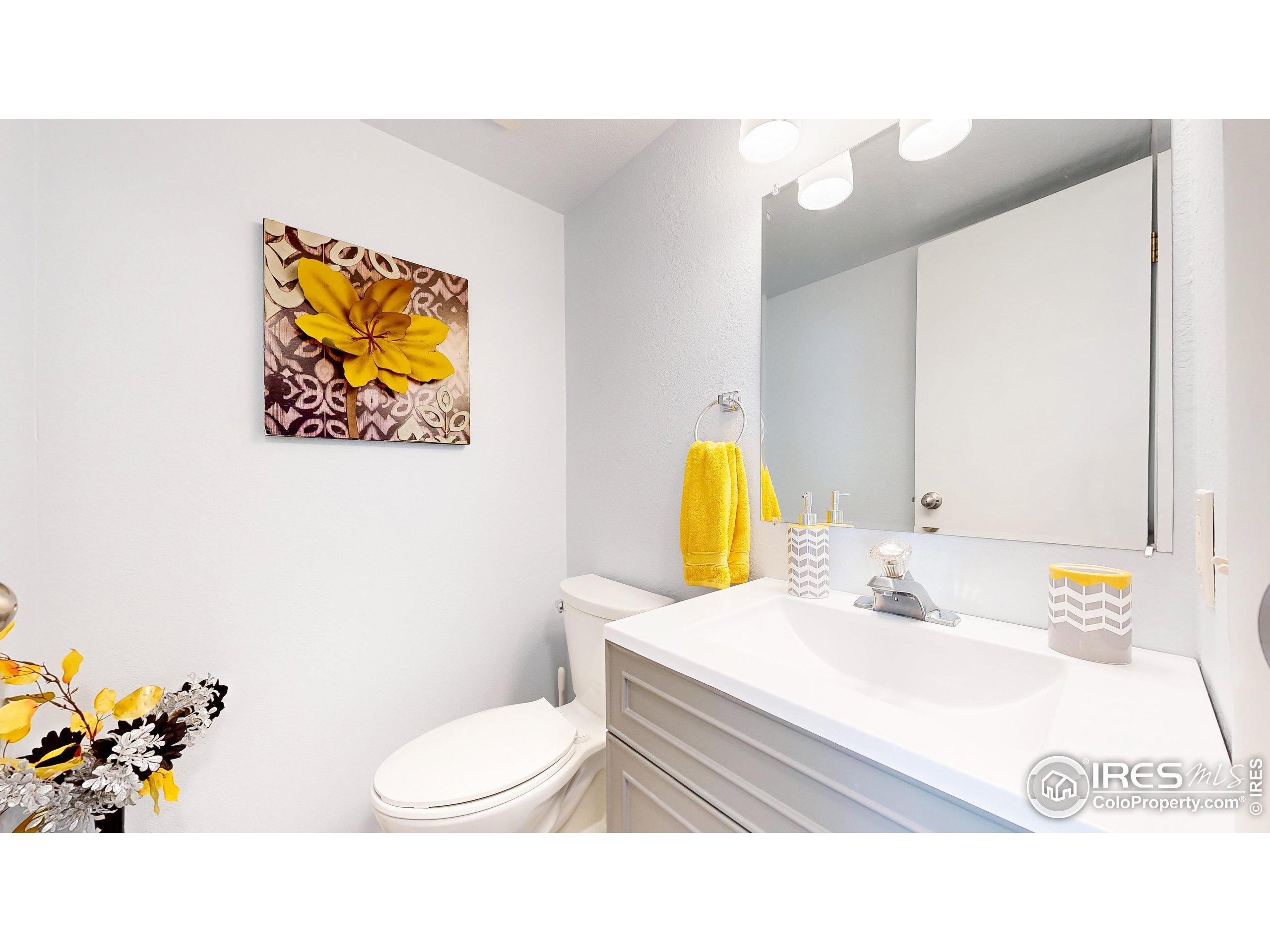 1705 Heatheridge Road, Unit K105 Fort Collins, CO 80526 - Photo 10 of 30 a bathroom with a sink mirror and toilet