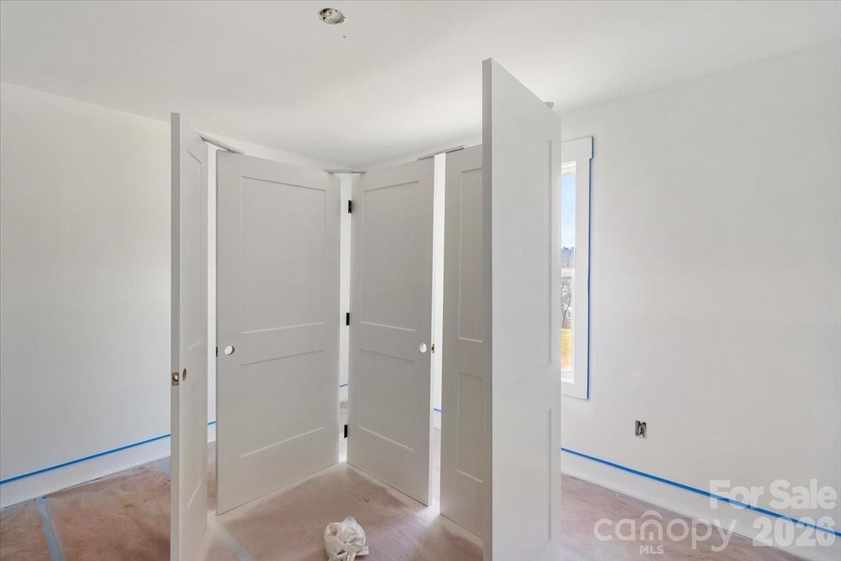 94 Baileys Cove Road, Unit 9 Marshall, NC 28753 - Photo 23 of 30 a bathroom with a shower and closet